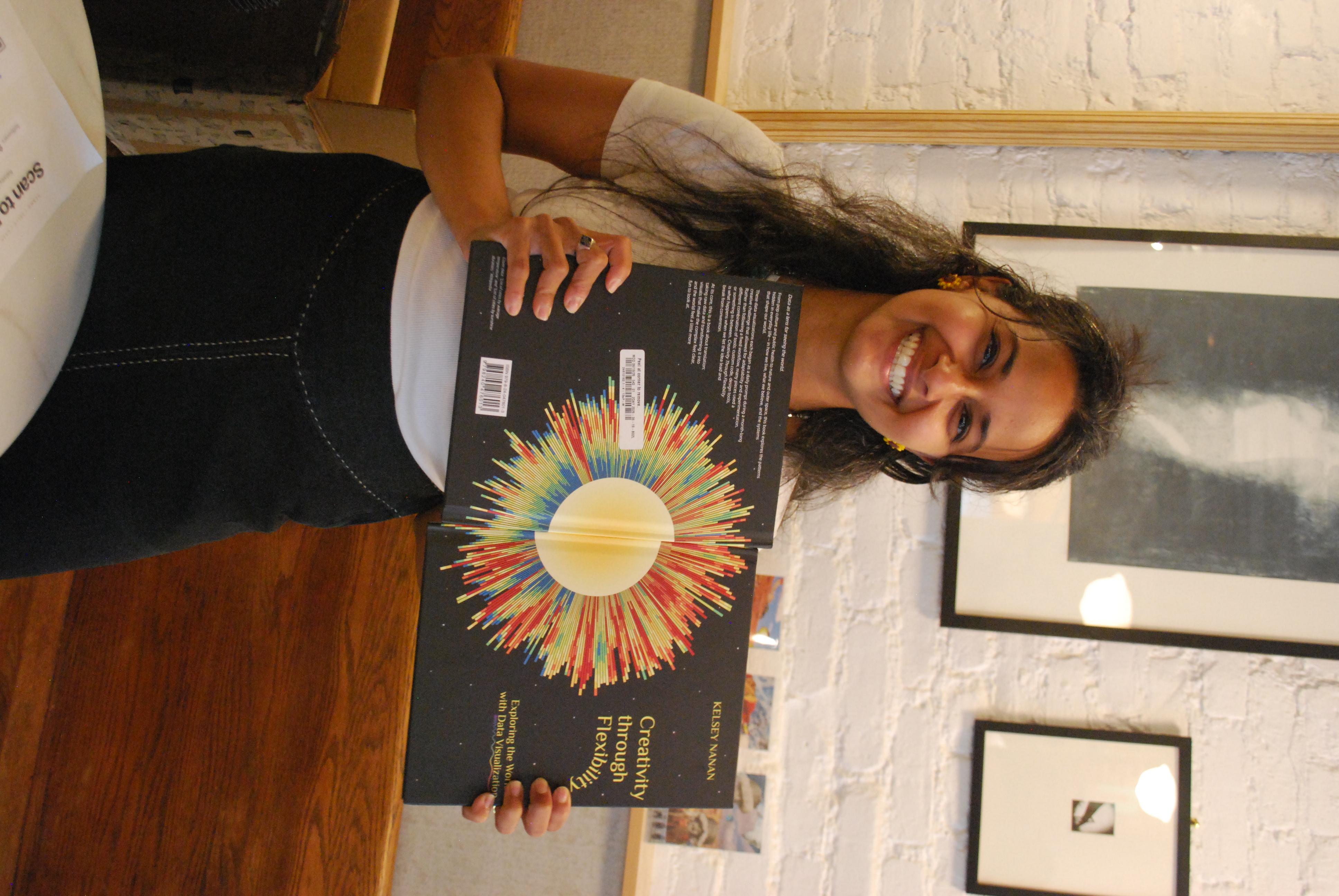 Kelsey holding copies of Creativity through Flexibility
